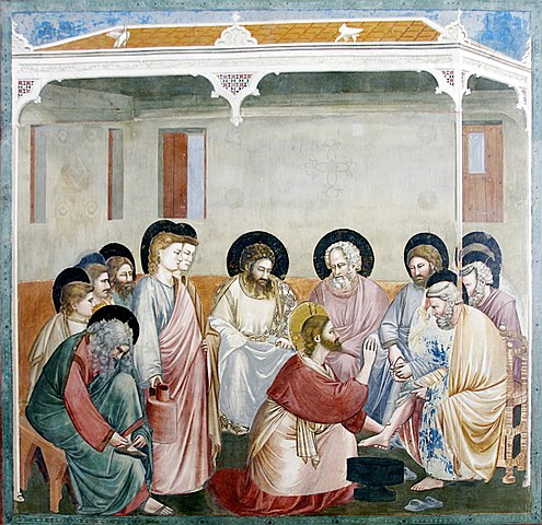 Das Fresko zeigt Jesus bei der Fußwaschung eines Jüngers, ein Symbol für Dienstbereitschaft, Demut und Liebe. Geschaffen von Giotto di Bondone, gehört es zu den Meisterwerken der italienischen Frührenaissance in der Cappella degli Scrovegni, die für Giottos innovative Kunst bekannt ist.